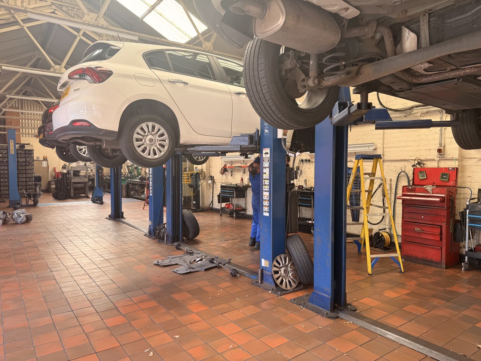 A car raised on a ramp inside the Top Gear Transmissions workshop, Liverpool